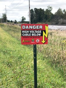Sign saying Danger High Voltage Cable Below