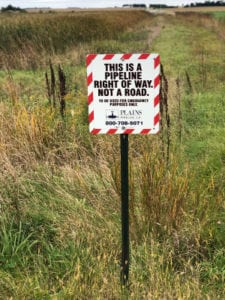 Sign saying this is a pipeline right of way not a road.